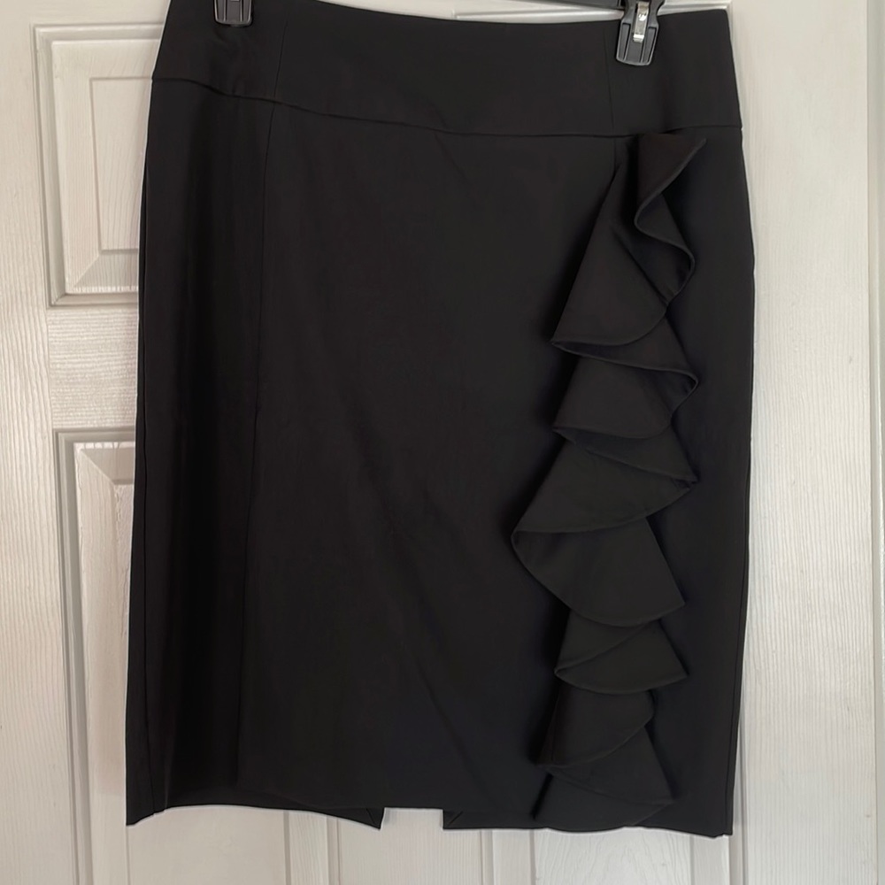 Black skirt with ruffles down one side.